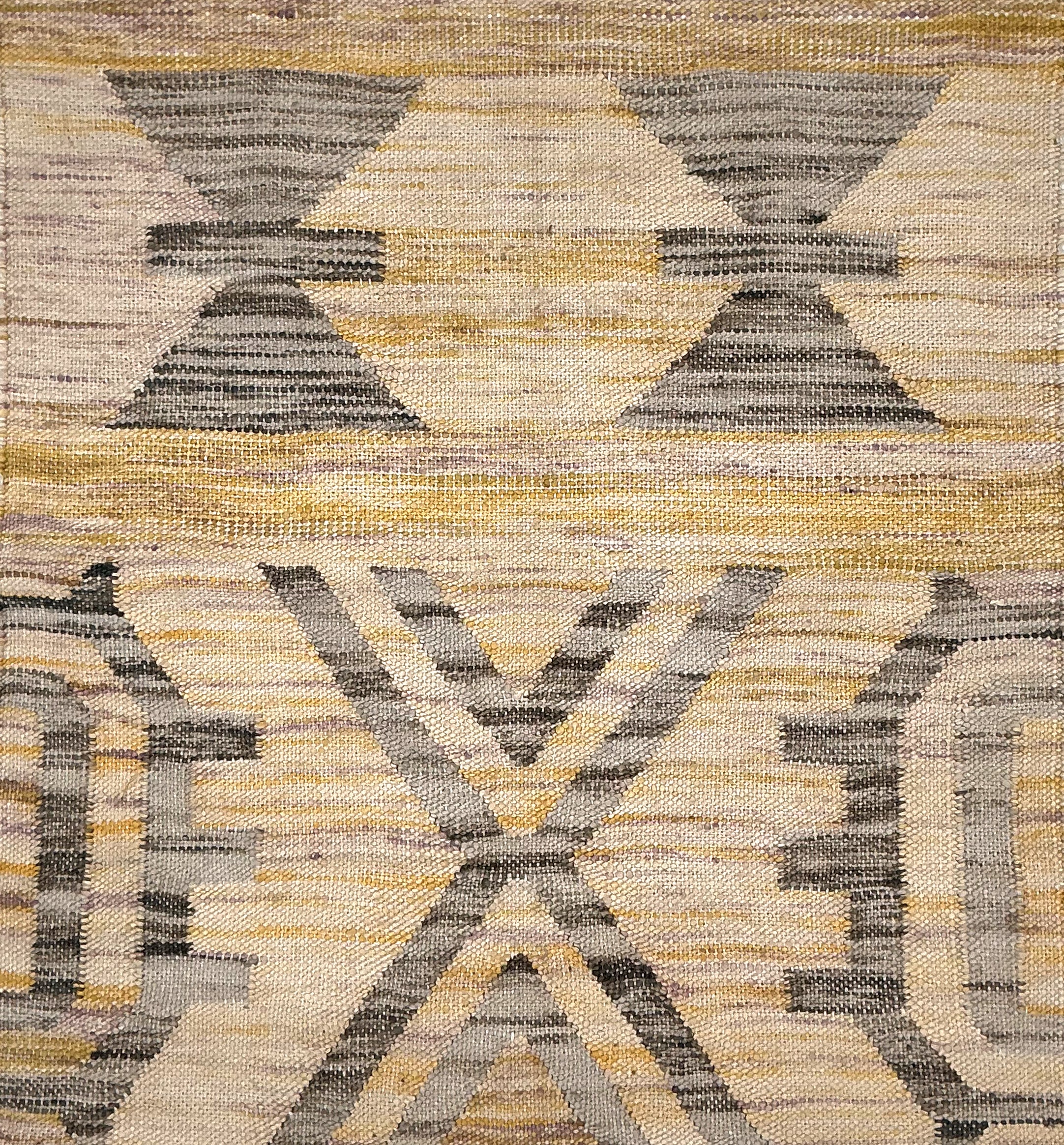 Patterned rug with geometric design in beige, brown, and gray colors