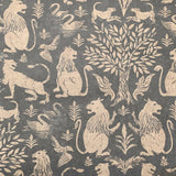 Detail of wallpaper in a lion and plant print in cream on a mottled gray field.