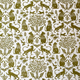 Printed fabric in a lion, mixed animal and plant pattern in olive on a white field.