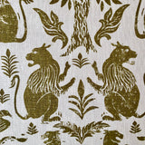 Detail of a printed fabric in a lion, mixed animal and plant pattern in olive on a white field.