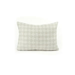 Back view of a rectangular throw pillow with a repeating cream and greige diamond field.