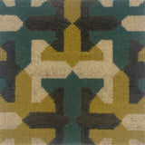Close-up of a geometric patterned rug with green, brown, and beige colors.