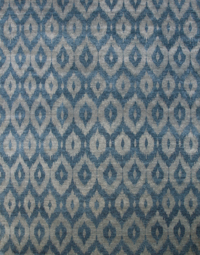 Full size rendering of a green and turquoise silk rug woven in an ikat geometric pattern.