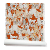 Partially unrolled wallpaper with a pattern of many different types of illustrated watercolor dogs. Background is red.