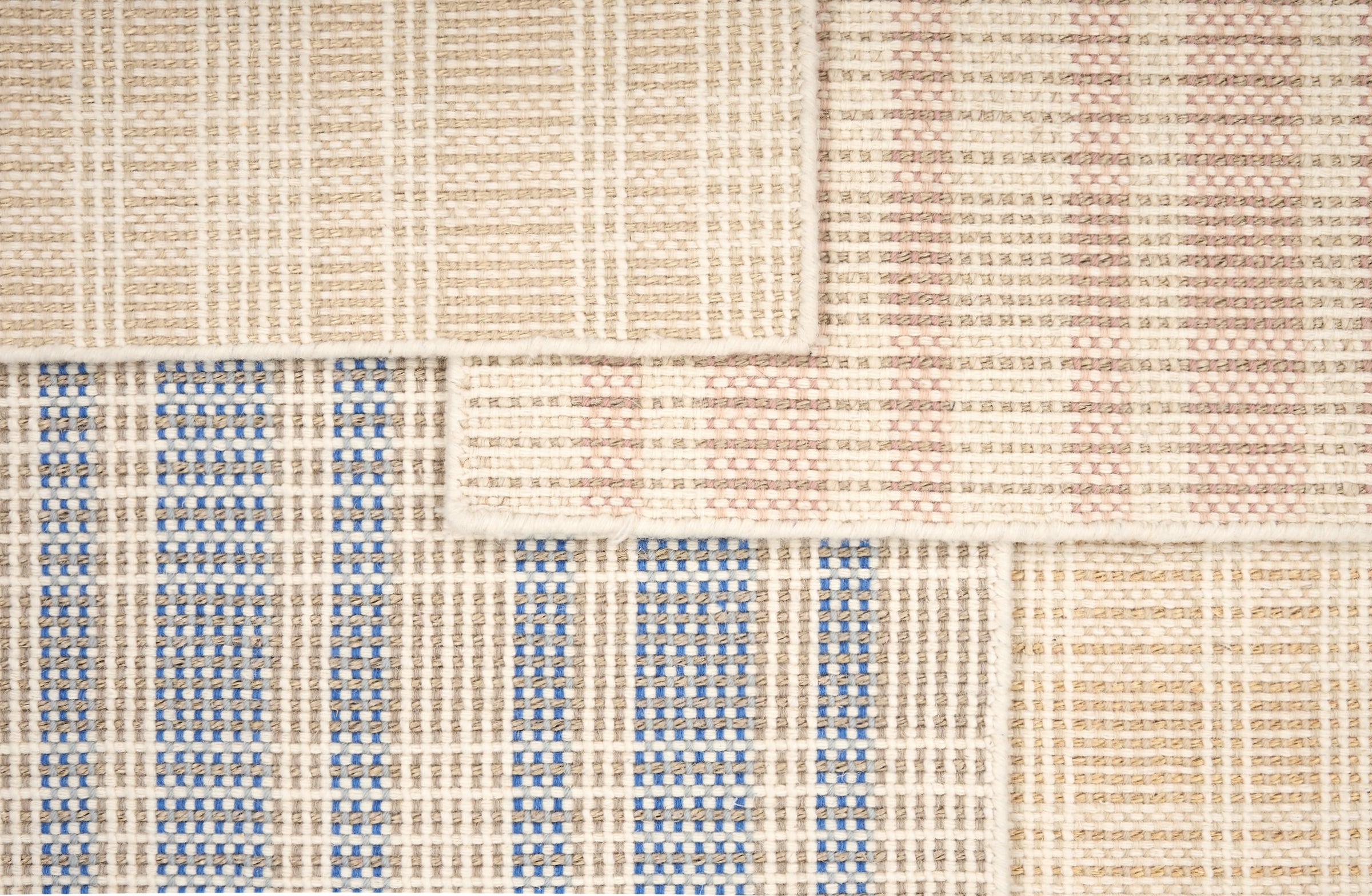 Broadloom rug samples in pastel colors in a plaid pattern