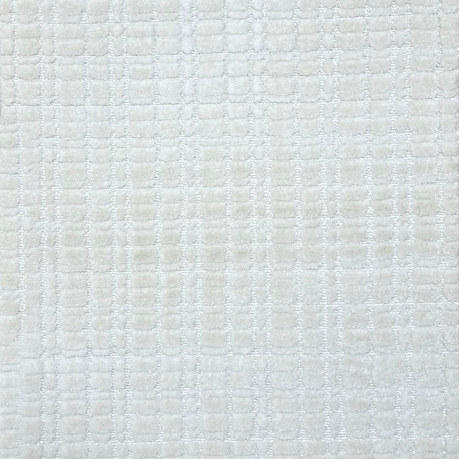 Broadloom carpet in a textural grid in white.