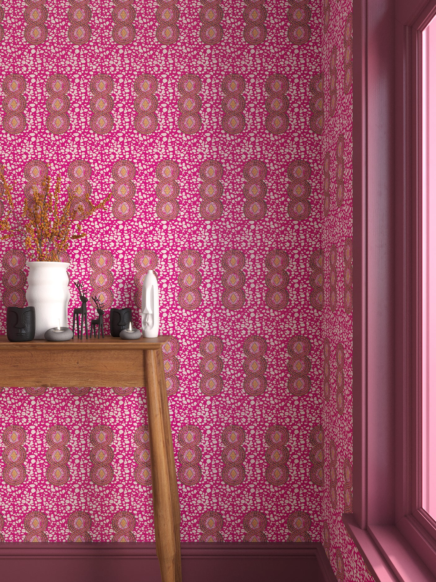 Interior with bright pink geometric wallpaper and matching trim with a wooden console table with white ceramic vases and mini ceramic sculptures. 