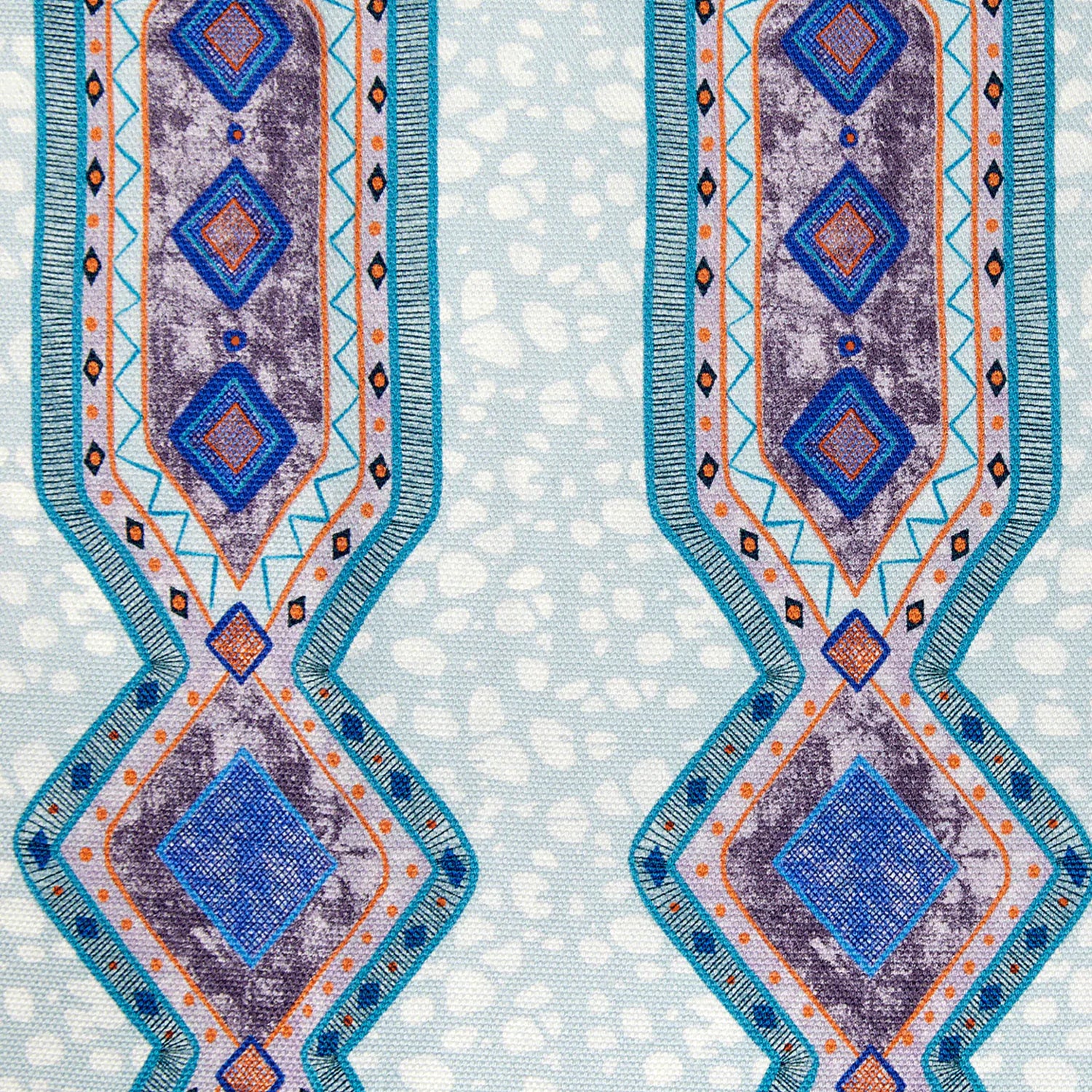 Detail of fabric in a geometric stripe pattern in shades of blue, orange and navy.