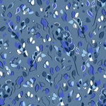 Detail of fabric in a painterly leaf print in shades of white, blue and navy on a blue field.
