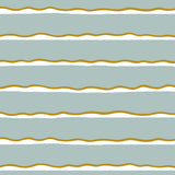 Detail of fabric in a wide undulating stripe pattern in mustard and white on a light blue field.