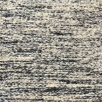 Textural bouclé broadloom carpet in charcoal and cream.