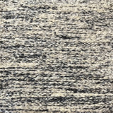 Textural bouclé broadloom carpet in charcoal and cream.