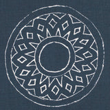 Detail of fabric in a repeating circular geometric print in white on a navy field.