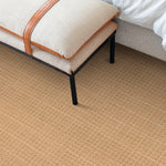 Bedroom scene with a solid textural carpet in warm brown. 