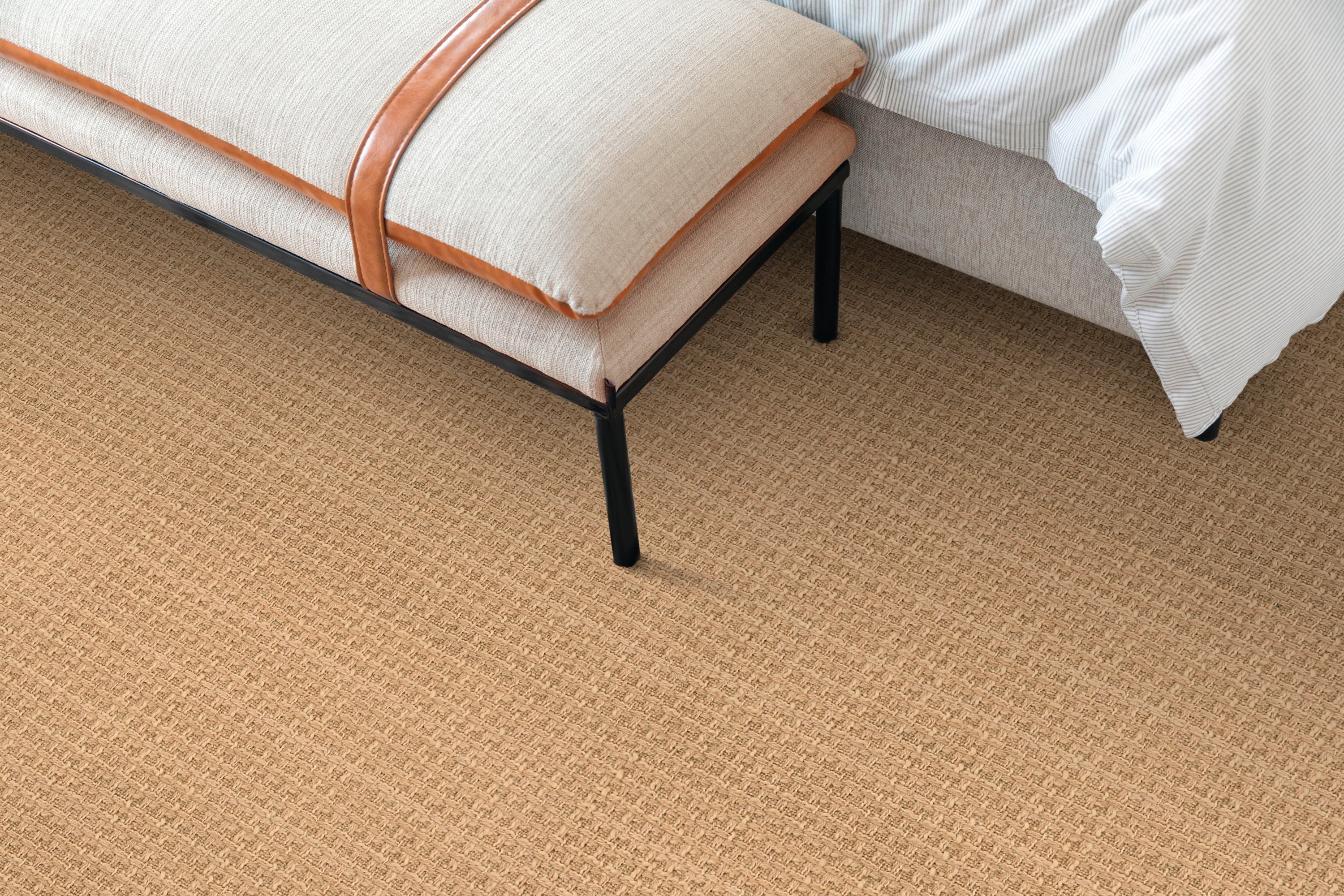 Bedroom scene with a solid textural carpet in warm brown. 