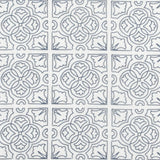 Detail of fabric in a damask lattice print in navy on a white field.