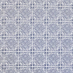 Detail of fabric in a damask lattice print in navy on a white field.