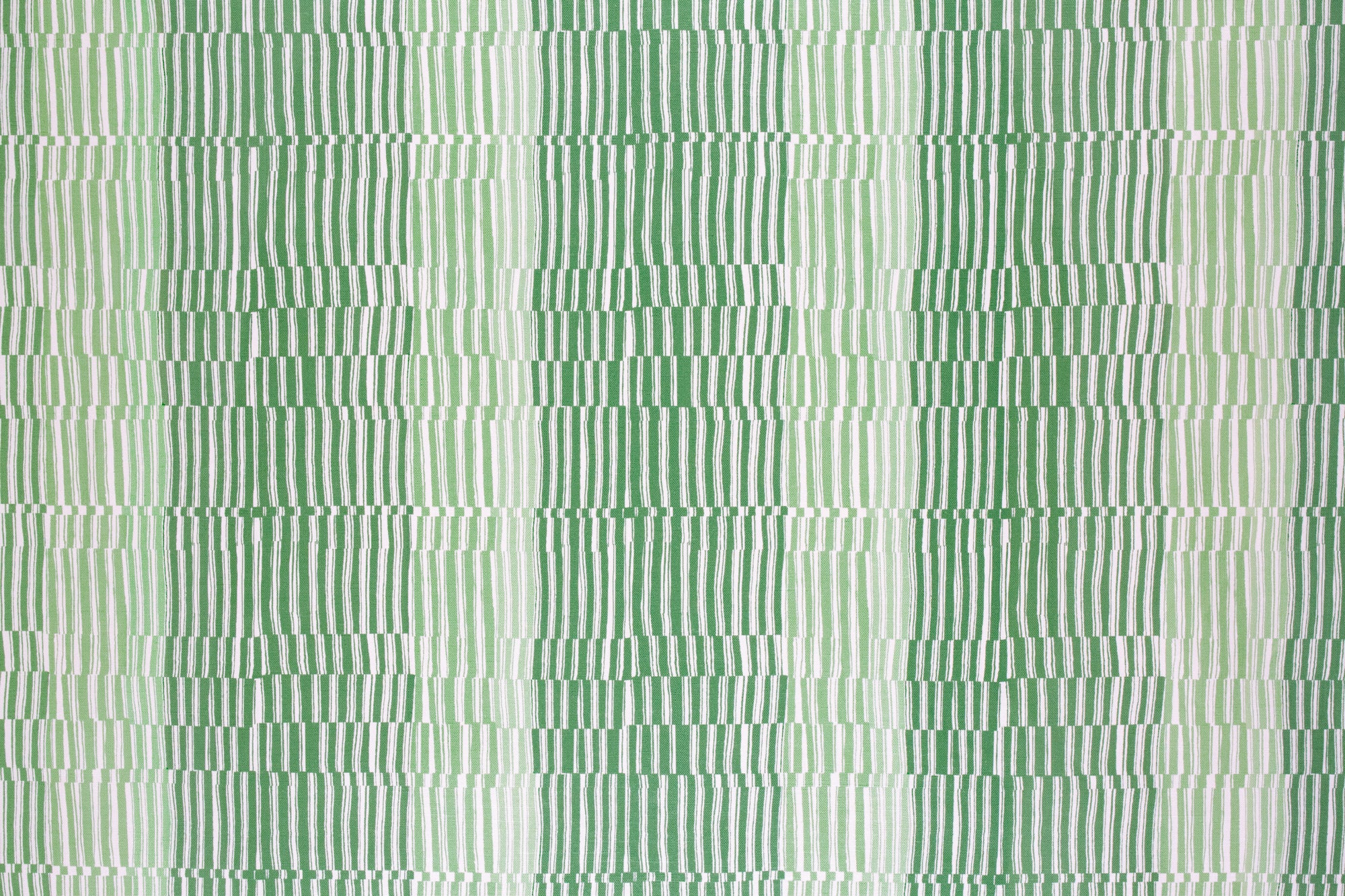 Detail of fabric in a dense broken stripe print in shades of green and white.