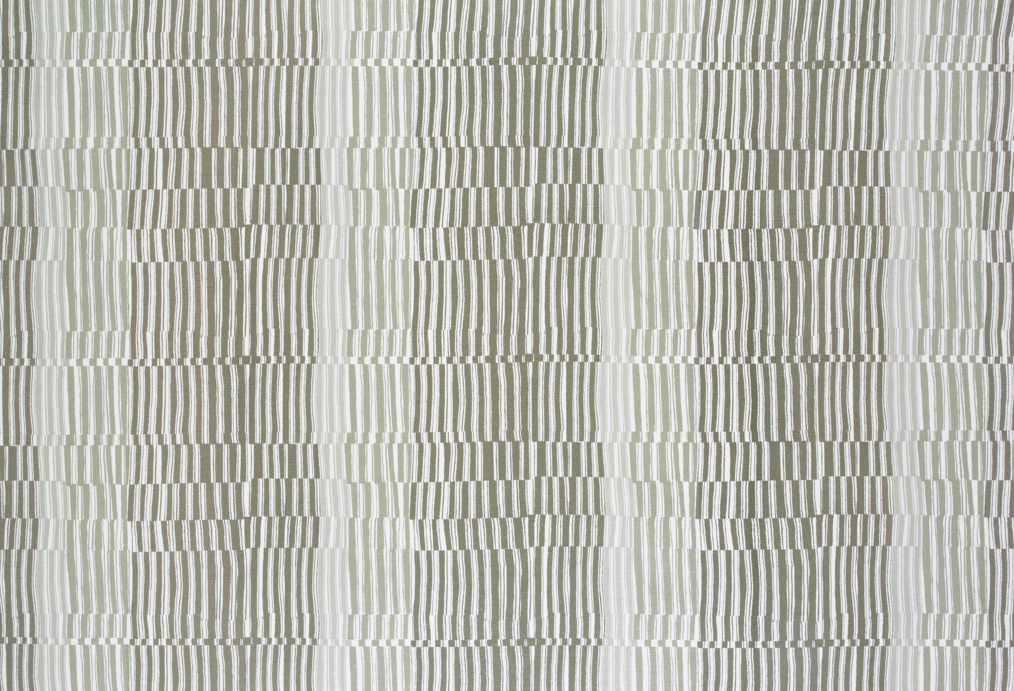 Detail of fabric in a dense broken stripe print in shades of tan, brown and white.