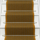 Striped flatweave runner in mustard black and ivory on white staircase