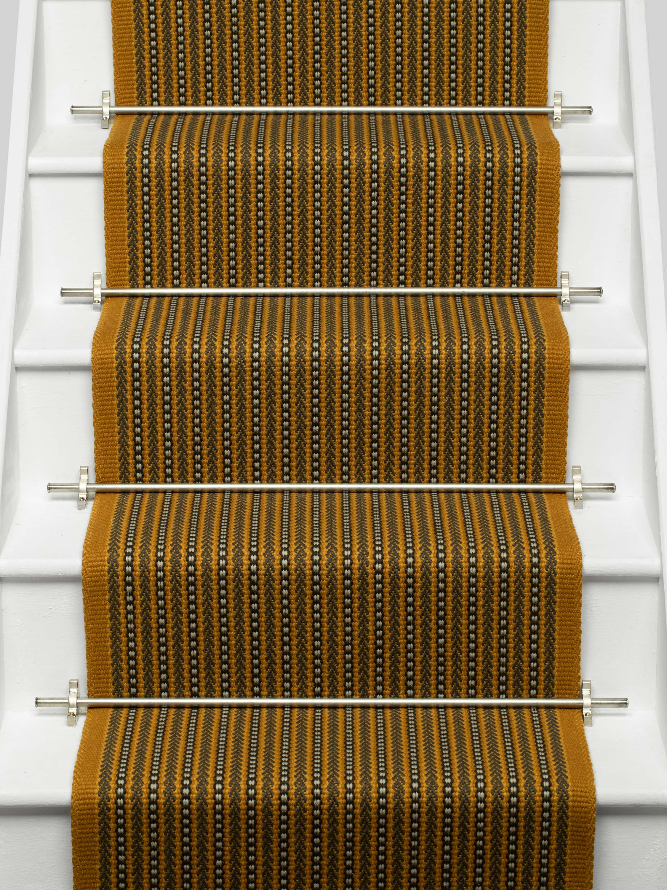Striped flatweave runner in mustard black and ivory on white staircase