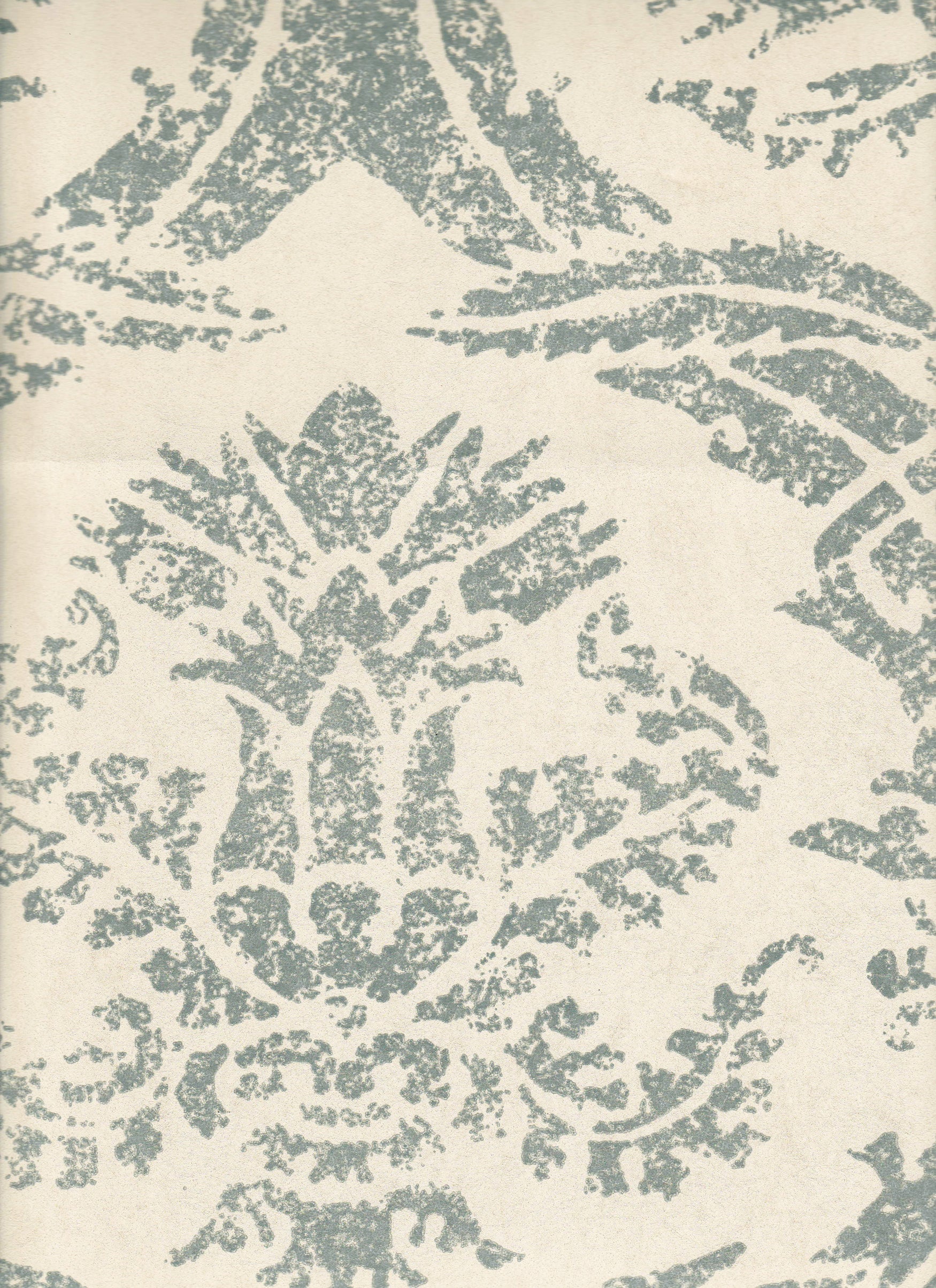 Detail of wallpaper in a mottled damask print in blue-gray on a cream field.