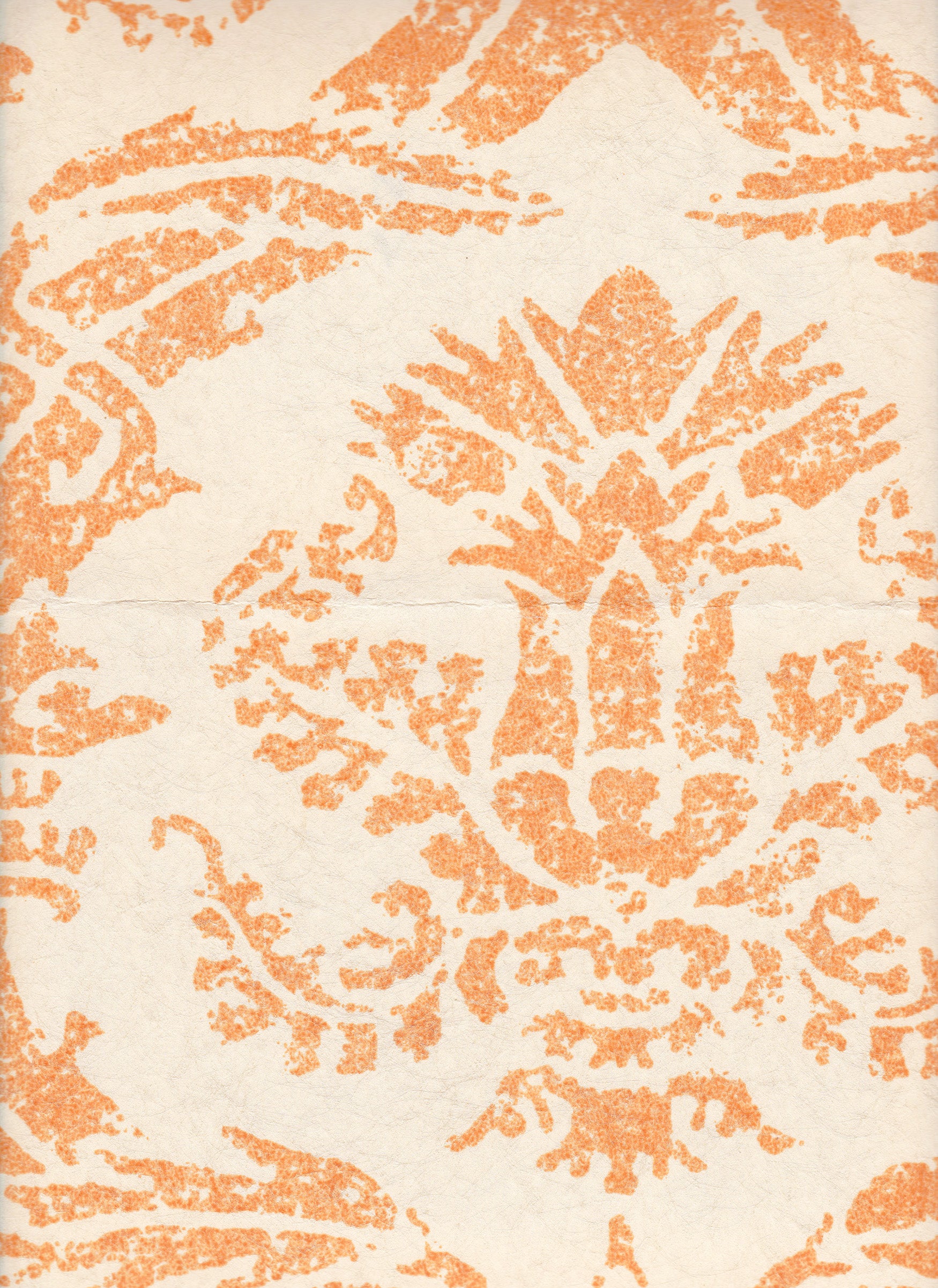 Detail of wallpaper in a mottled damask print in orange on a cream field.