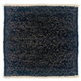 Black textured rug with white border on a white background