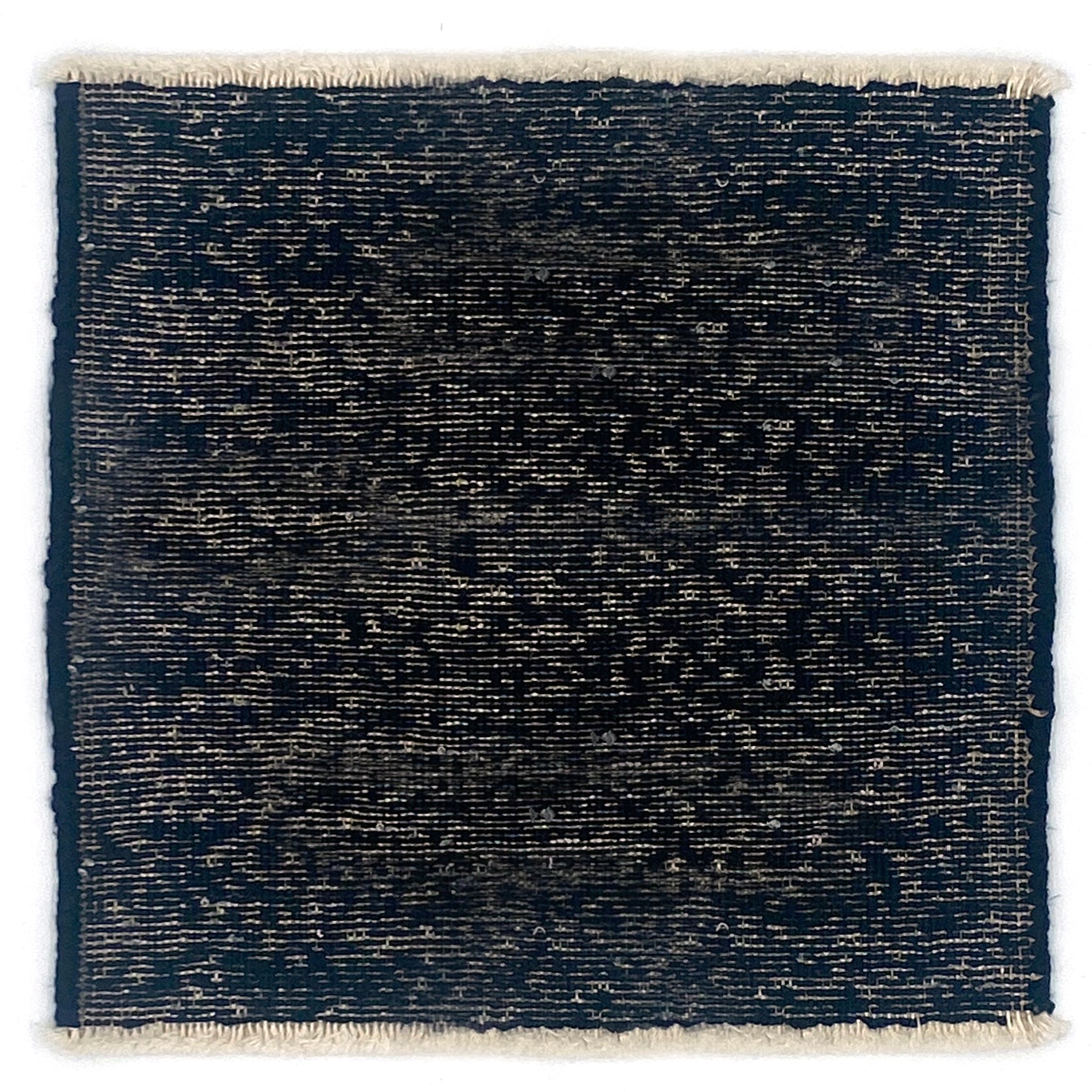 Black textured rug with white border on a white background