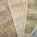 Close up of textured broadloom carpet samples in array of colors. 