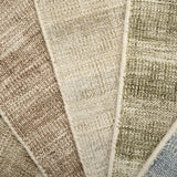 Close up of textured broadloom carpet samples in array of colors. 