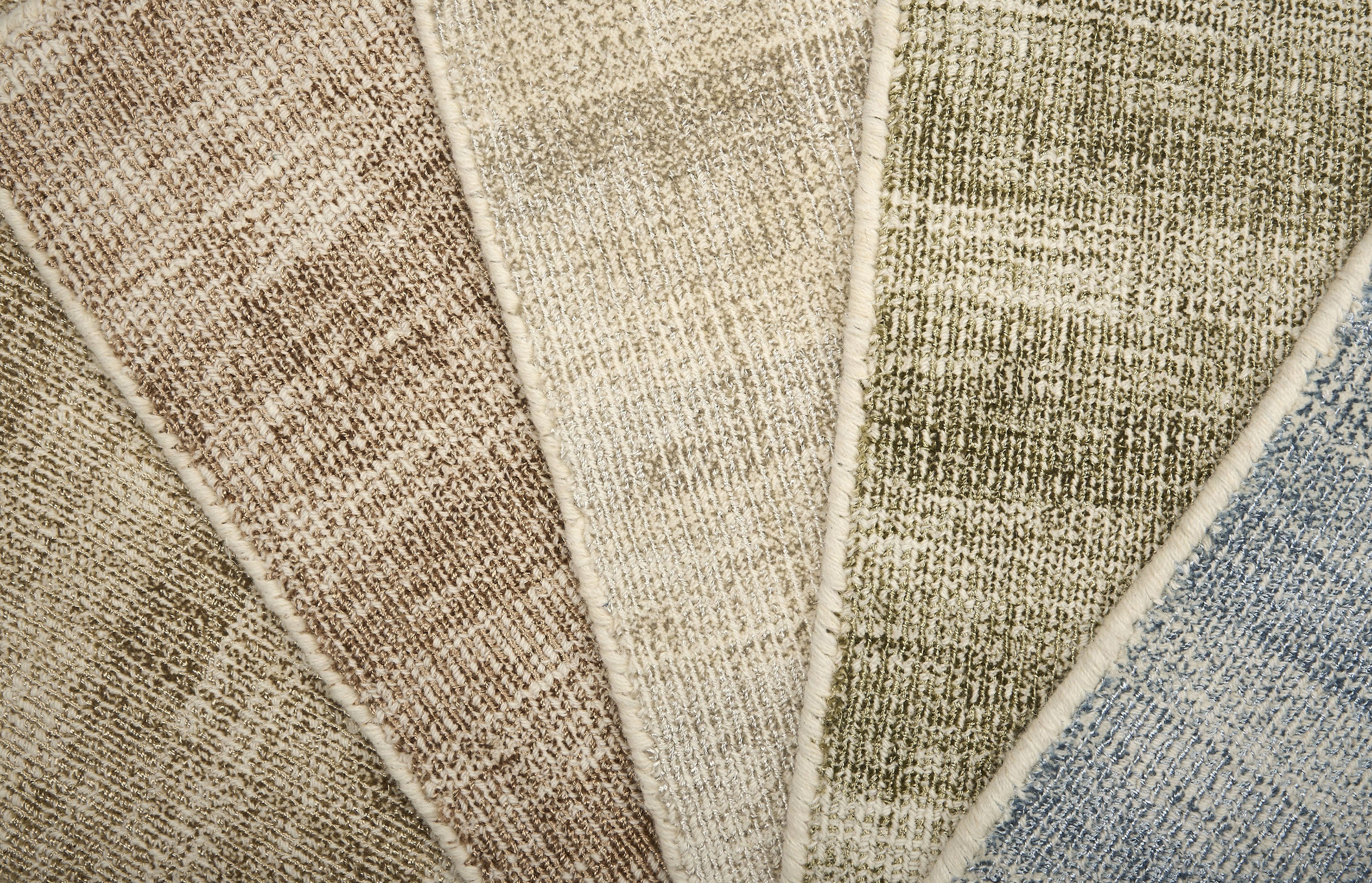 Close up of textured broadloom carpet samples in array of colors. 