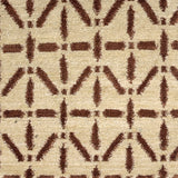 Handknotted rug with brown linear design on a cream field. 