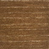 A close-up of a brown handknotted carpet with horizontal brushed lines 