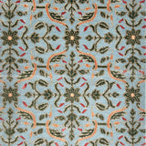 Decorative rug with intricate pattern on a blue background