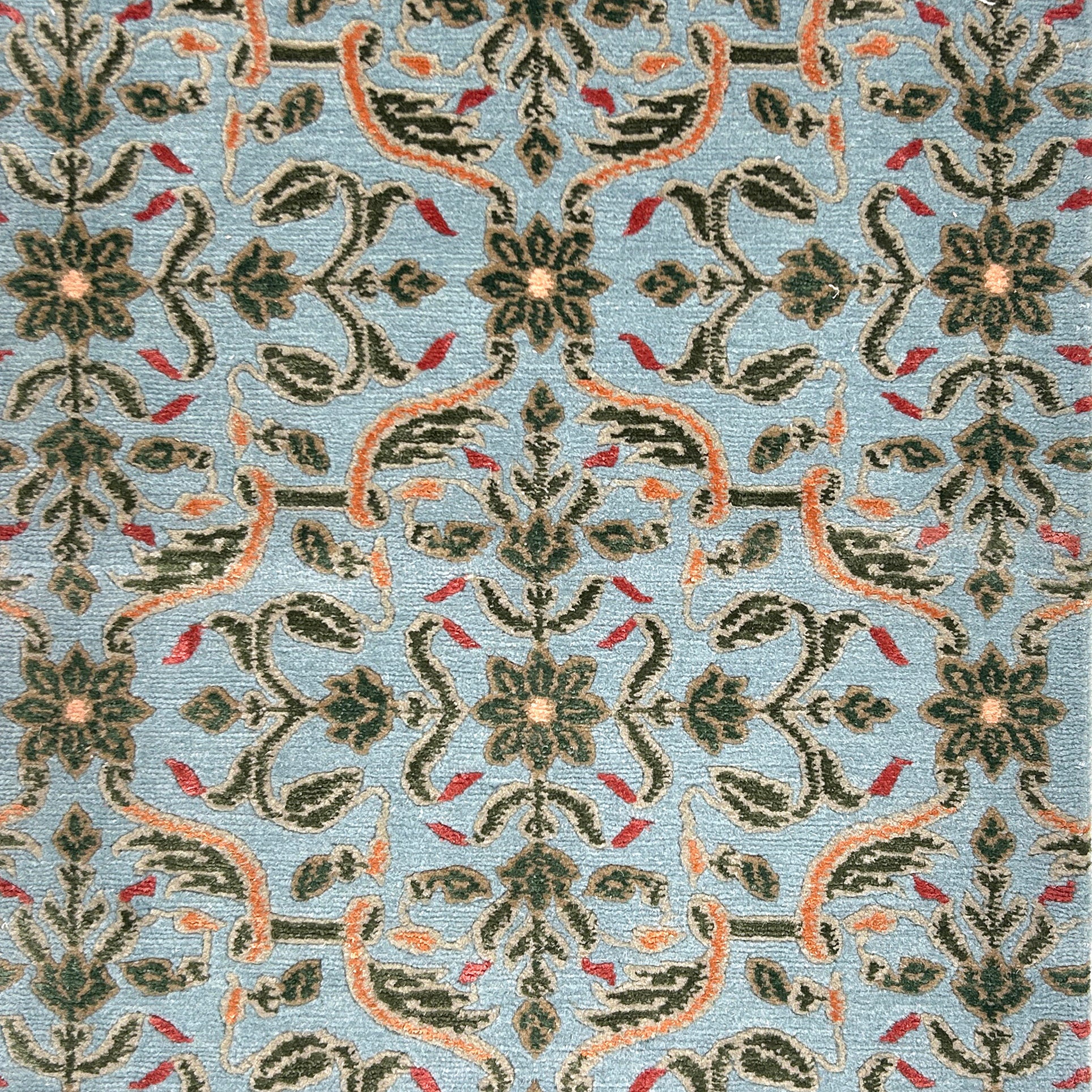 Decorative rug with intricate pattern on a blue background