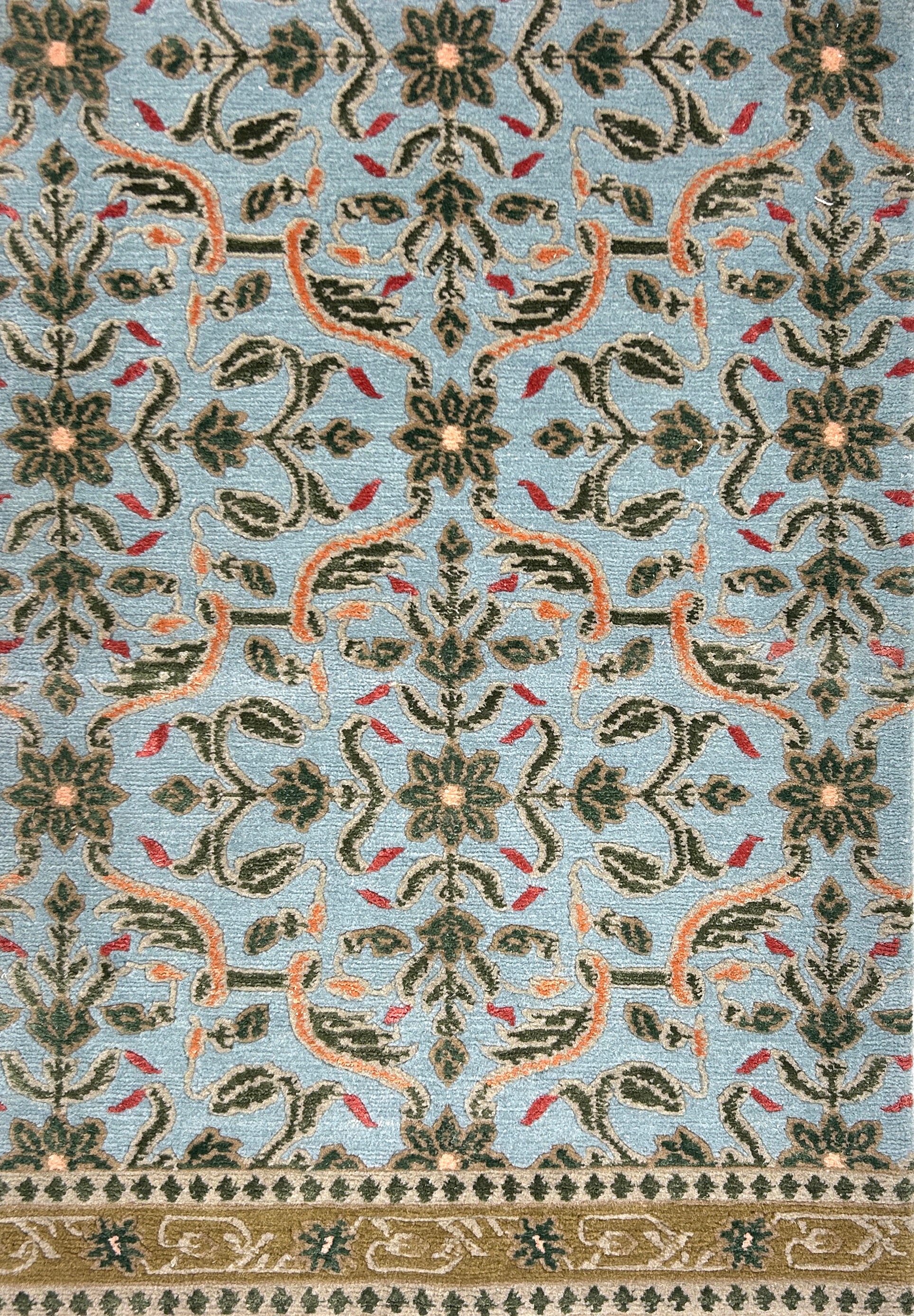 Decorative rug with intricate pattern on a blue background