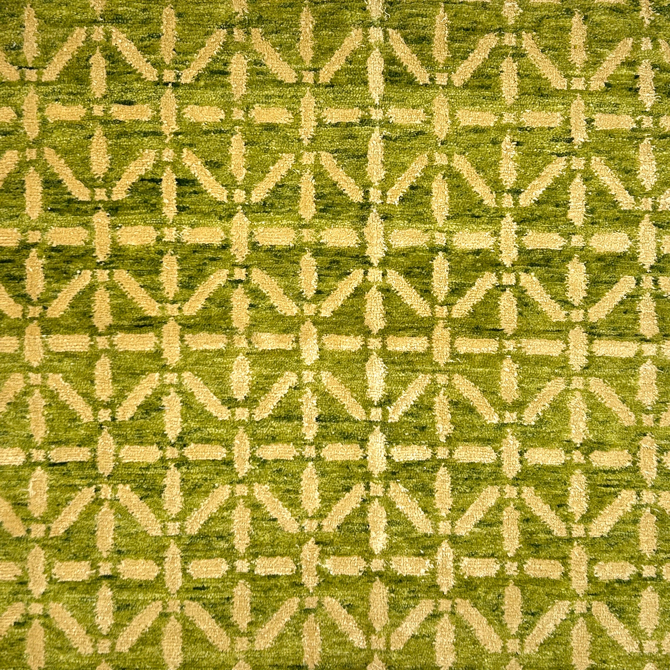 Patterned rug with geometric design on a bight green background