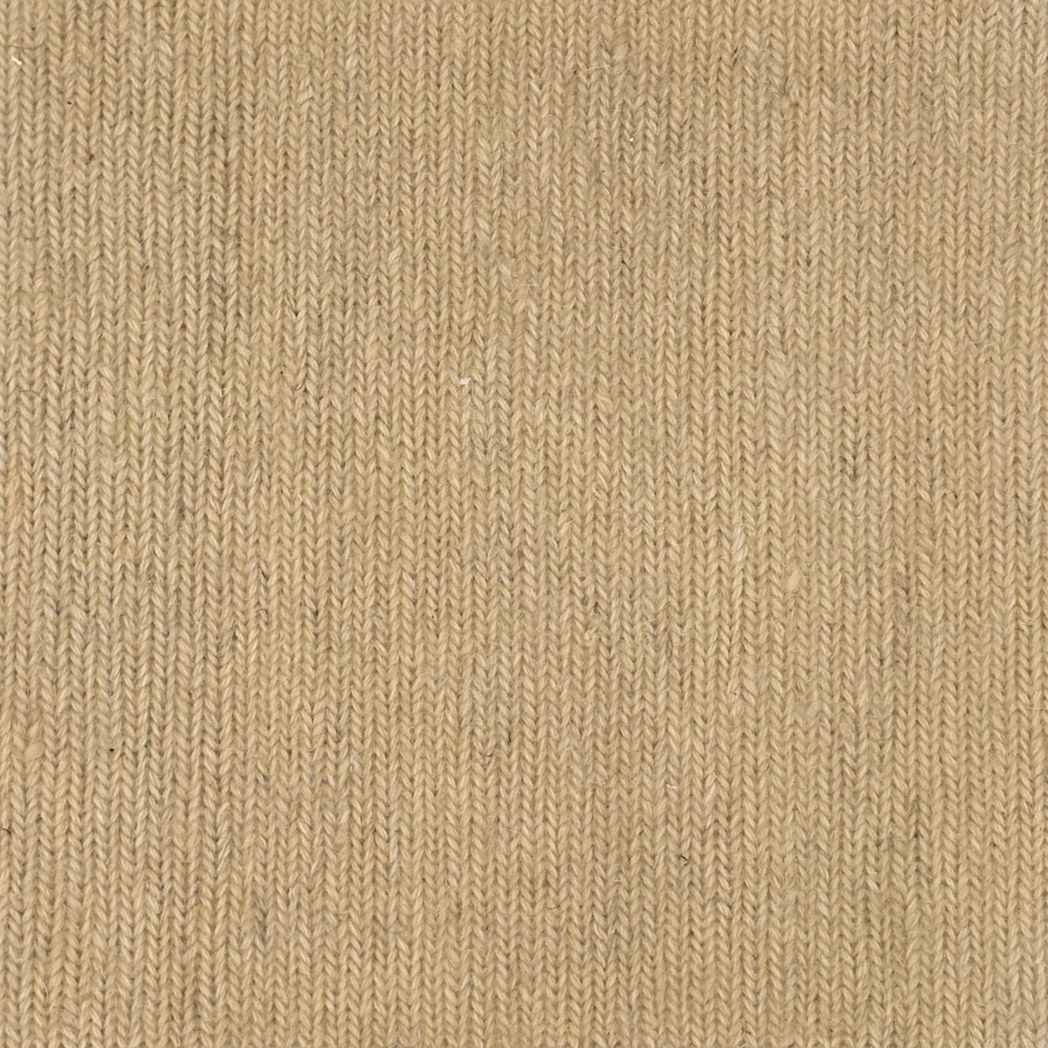 Close up of a carpet with a herringbone weave in beige.