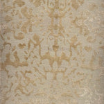 Handknotted rug sample in an organic abstract pattern in tan. 