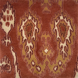 Close-up of a patterned rug with intricate ikat designs on a brown background