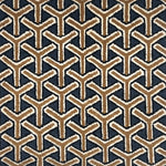 A close-up of a handknotted rug featuring a repeating geometric Y-shaped pattern in tan and off-white on a dark navy background.