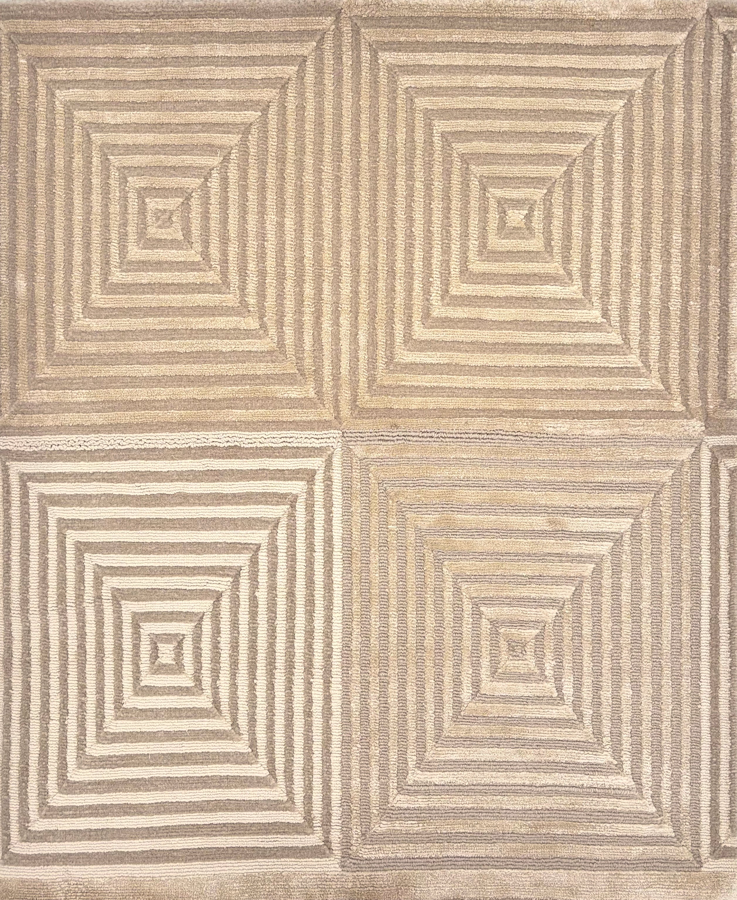 Handknotted rug sample in a nested repeating square motif in shades of taupe.