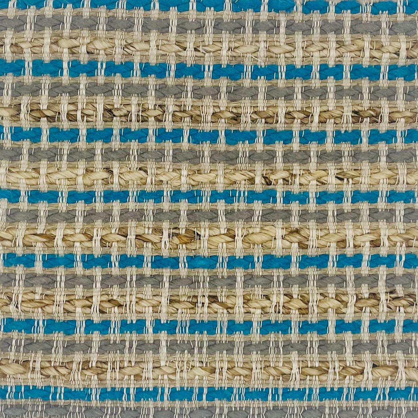 Woven rug swatch in natural fibers in  tan, grey and turquoise stripe pattern
