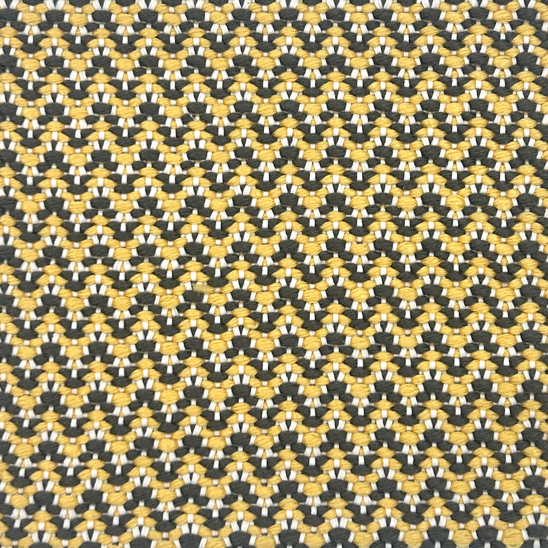 Patterned rug with a black and yellow chevron design