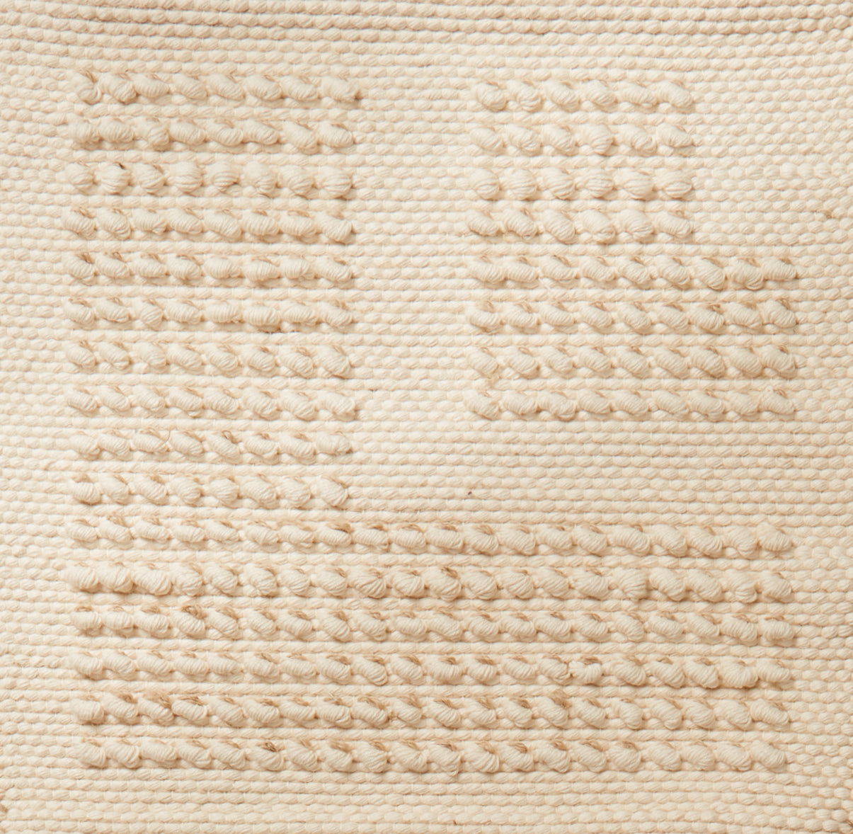 Flatwoven rug with a raised border corner design in cream.