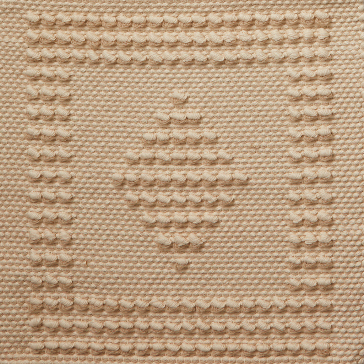 Flatwoven rug with a raised border and diamond design in tan and cream.