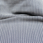 Detail of a draped hand-woven cotton striped fabric in navy blue and white.