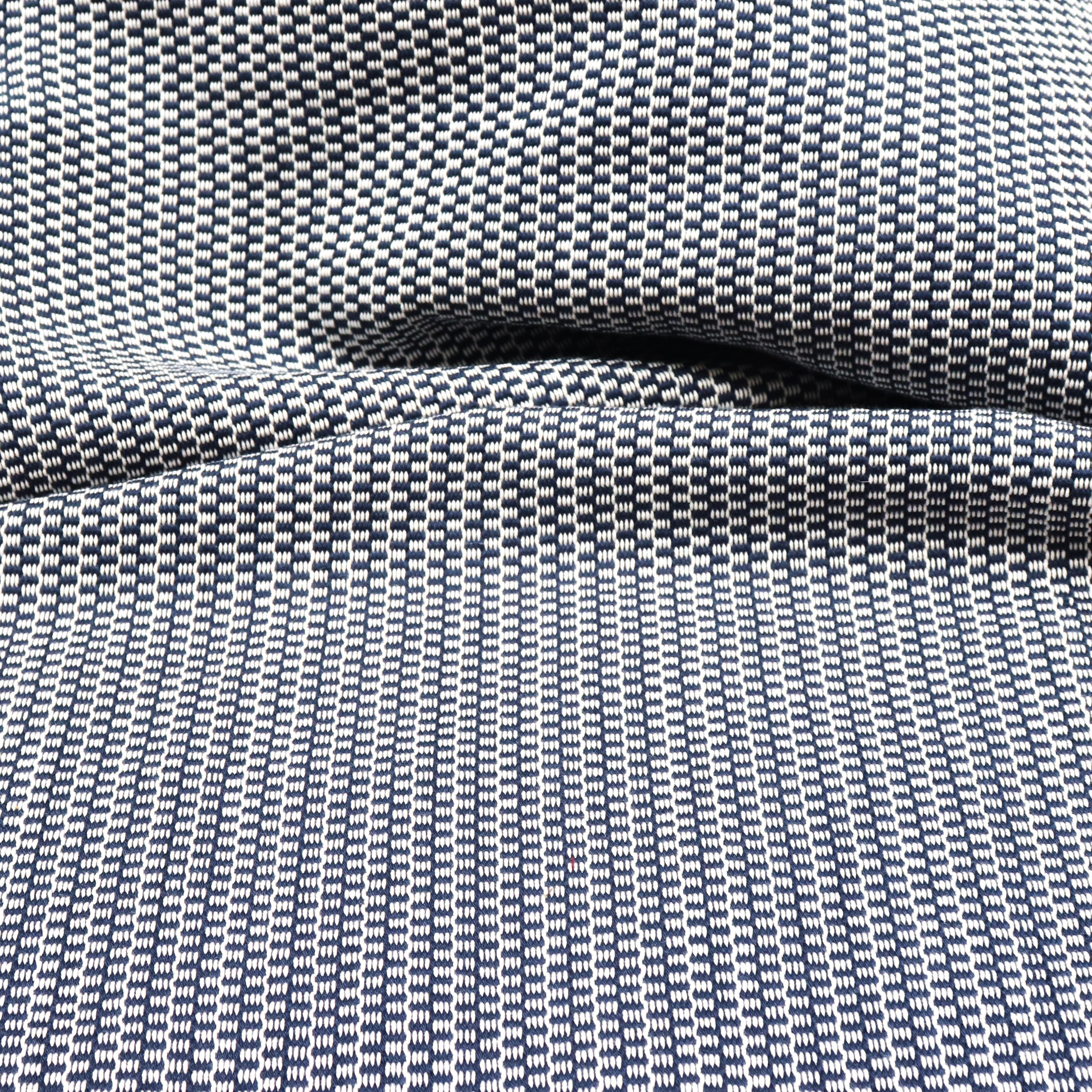 Detail of a draped hand-woven cotton striped fabric in navy blue and white.
