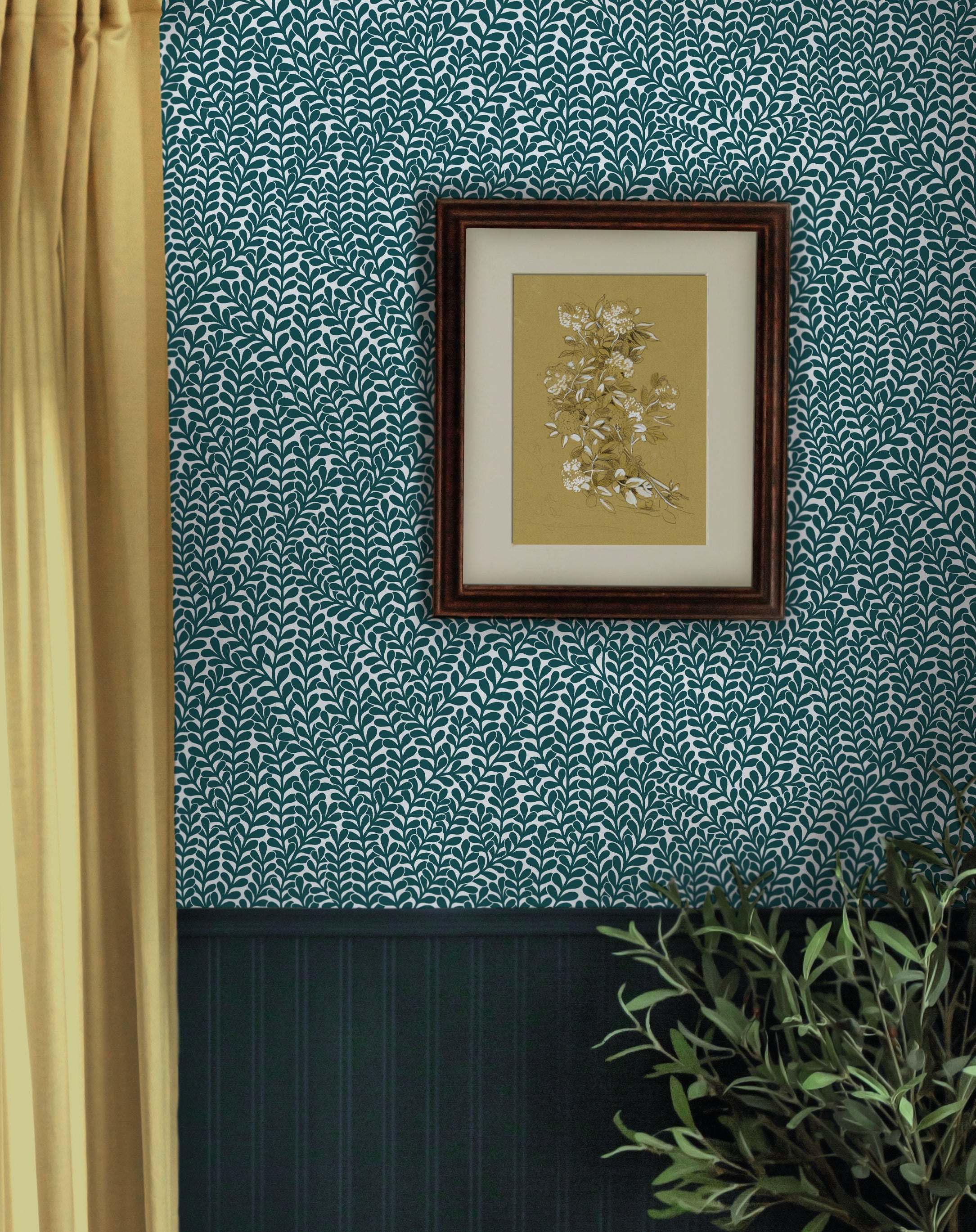 A floral painting hangs on a wall papered in a scrolling stem and leaf print in turquoise on a white field.